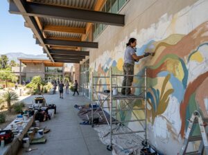 Muralist working on a Covina public art wall